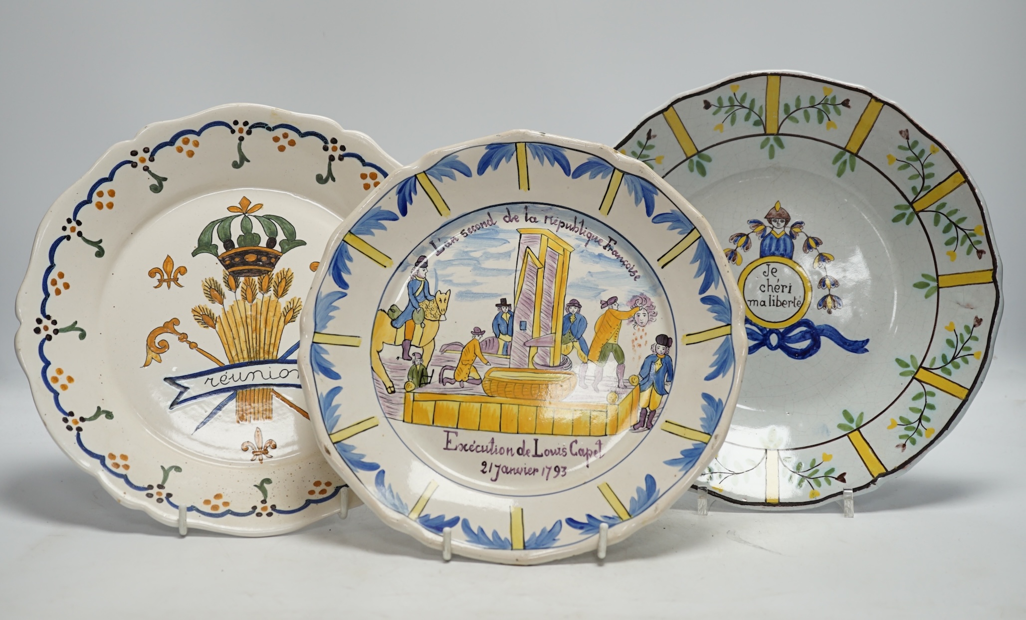 A collection of twenty 18th/19th century French faience polychrome and blue and white Revolution commemorative plates and three others, largest 27cm diameter (23). Condition - condition varies poor to good